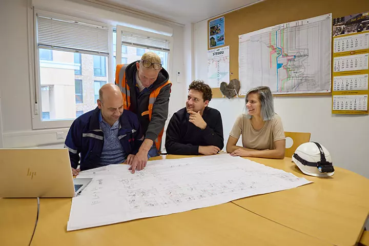 Colleagues talking and working together at Eneco